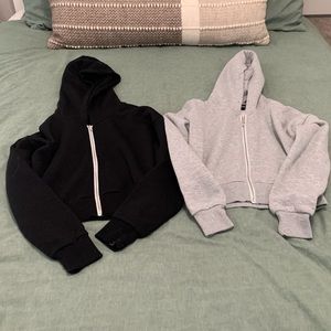 Grey and black set of cropped hoodies.